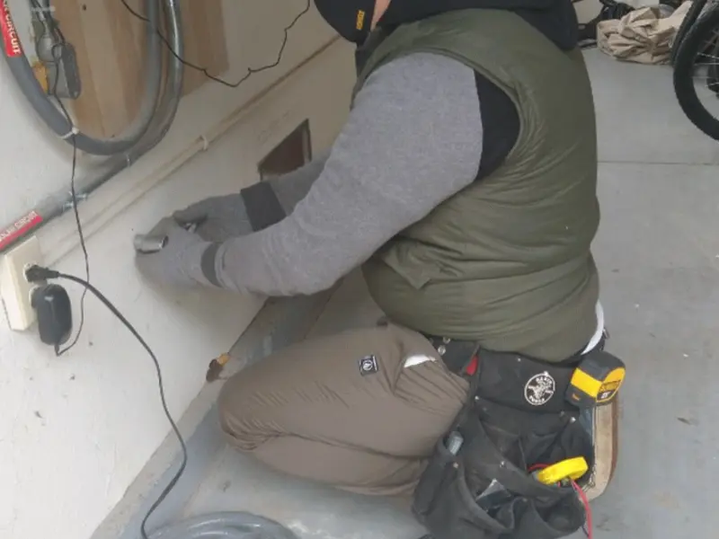 Electrician performing outlet wiring in a Weaverville garage